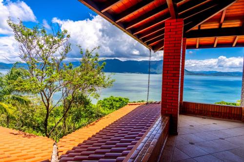 a view of the water from the balcony of a house at Mansão VOAR in Florianópolis