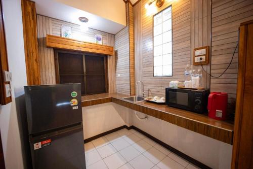 a small kitchen with a sink and a refrigerator at Le-Mao Chiang Dao in Chiang Dao