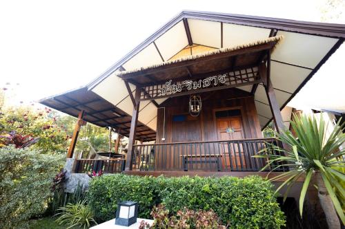 a house with a sign on the front of it at Le-Mao Chiang Dao in Chiang Dao
