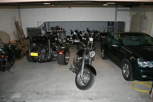 a group of motorcycles parked in a garage at Logis Gourmet & Relax Hotel De La Sure in Esch-sur-Sûre