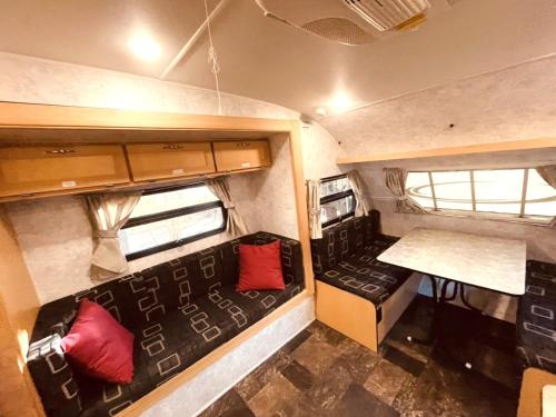 an interior view of an rv with red pillows at DogrunCafe & Resorts JENNIE West-Karuizawa in Miyota