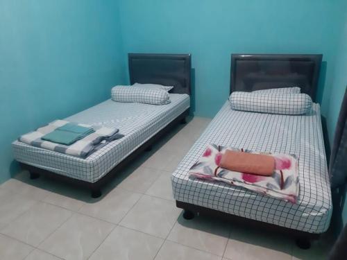 Кровать или кровати в номере Bumi Abah Homestay