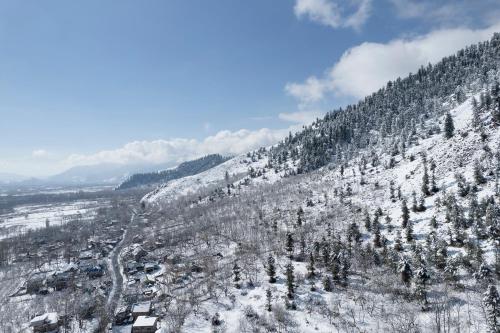 an aerial view of a snow covered mountain at Hotel Sparrow in Pahalgām