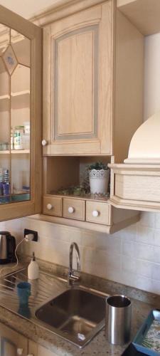 a kitchen counter with a sink and a cabinet at Patty's House in Finale Ligure