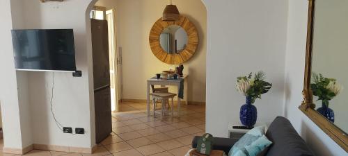 a living room with a couch and a mirror at Patty's House in Finale Ligure