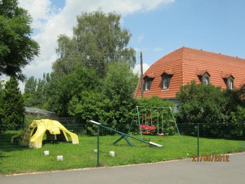 a playground in front of a house with a building at Hotel Landhaus Nassau in Meißen
