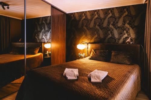 a bedroom with a bed with two towels on it at Villa It's Arctic Magic! in Rovaniemi