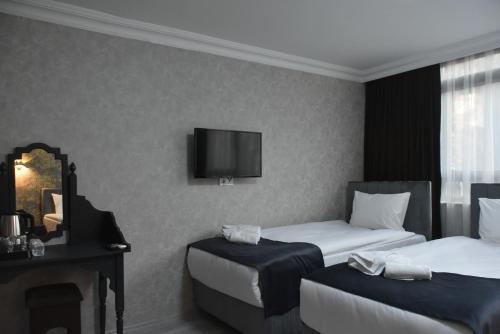 Ένα ή περισσότερα κρεβάτια σε δωμάτιο στο Palmera City Hotel