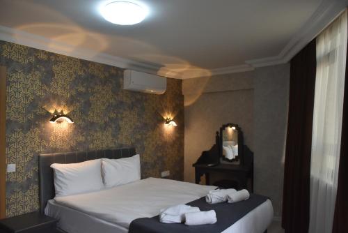Ένα ή περισσότερα κρεβάτια σε δωμάτιο στο Palmera City Hotel