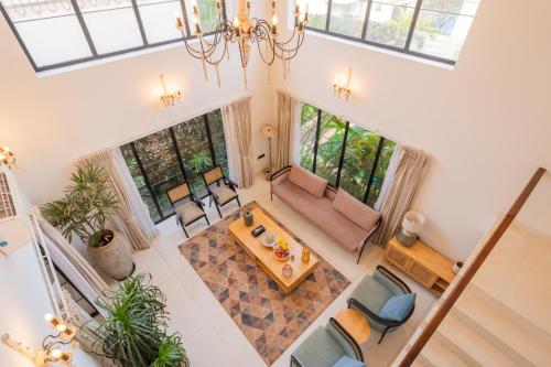 an overhead view of a living room with a table and chairs at ELIVAAS Bogenvilla Luxe 3 BHK Villa Near Ozran Beach in Assagao