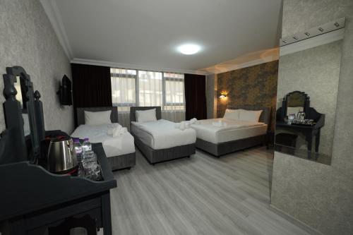 Ένα ή περισσότερα κρεβάτια σε δωμάτιο στο Palmera City Hotel