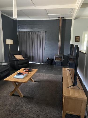 a living room with a couch and a coffee table at Back Creek Estate Cottage in Severnlea