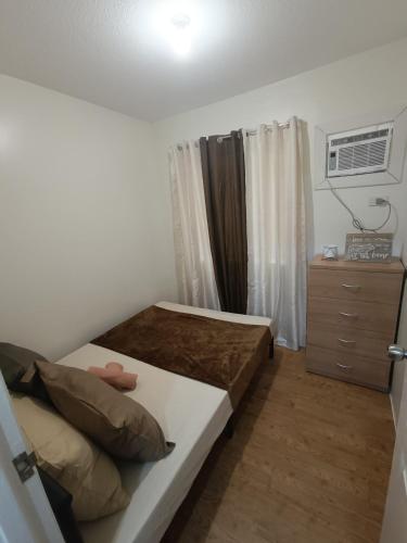 a small bedroom with a bed and a dresser at Sanremo Oasis by Beau Condotels in Cebu City