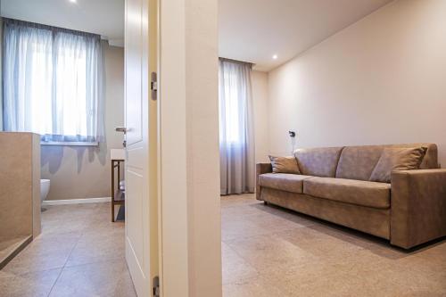 a living room with a couch in the middle of a room at Modena Relax Luxury Rent Rooms in Modena