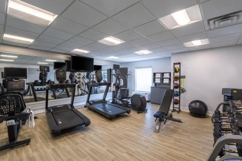 a gym with several treadmills and machines in a room at Holiday Inn Anderson by IHG in Anderson