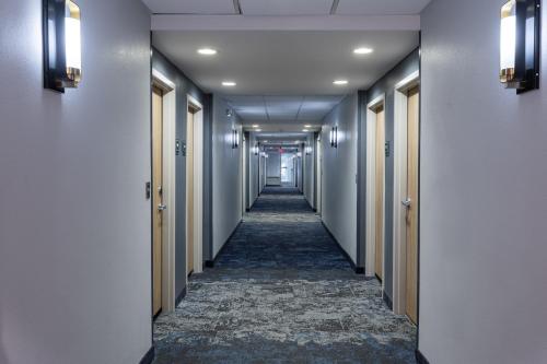 a corridor in a building with a long hallway at Holiday Inn Anderson by IHG in Anderson