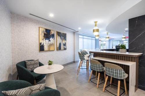 a bar in a restaurant with chairs and a counter at Holiday Inn Anderson by IHG in Anderson