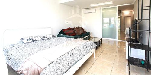 a bedroom with a bed and a glass table at Achuza near Horev renovated 3 room in Haifa