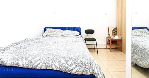 two pictures of a bedroom with a bed and a chair at Achuza near Horev renovated 3 room in Haifa