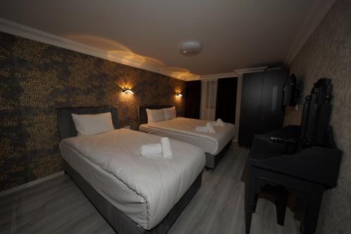 Ένα ή περισσότερα κρεβάτια σε δωμάτιο στο Palmera City Hotel