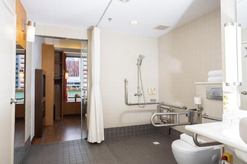a bathroom with a toilet and a shower at Ibis Singapore on Bencoolen - Newly Renovated in Singapore