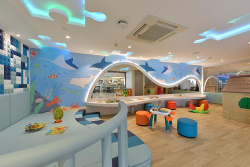 a childrens play room with a fish mural on the wall at Centre Point Plus Hotel Silom - Newly Renovated in Bangkok