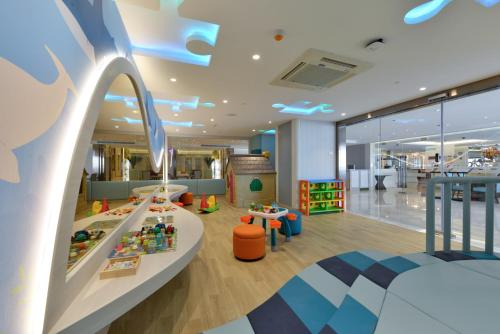 a childrens play area with a slide in a room at Centre Point Plus Hotel Silom - Newly Renovated in Bangkok