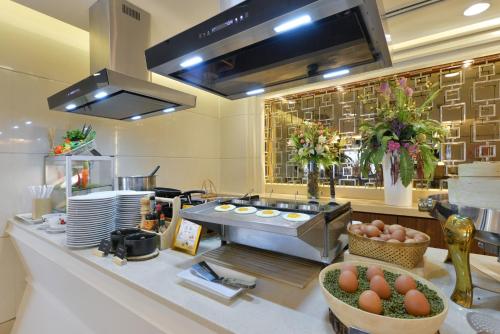 a kitchen with a counter with eggs in a bowl at Centre Point Plus Hotel Silom - Newly Renovated in Bangkok
