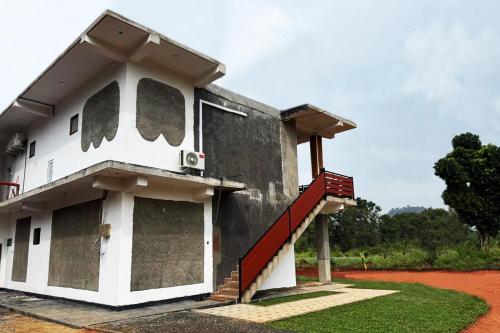 a building with a staircase on the side of it at The Wild Elephant Resort in Sigiriya