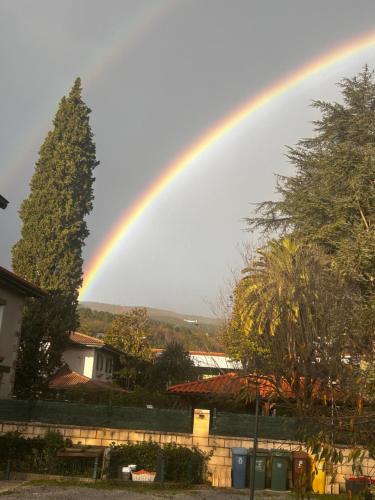 a rainbow in the sky over a city at Lekuona in Galdakao