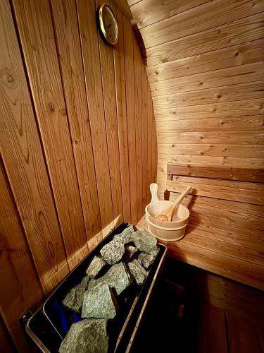 a inside of a sauna with a tray of rocks at Rieder Stubn Lodge in Ried im Oberinntal