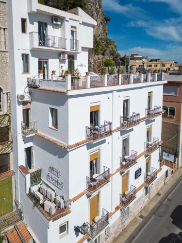 an apartment building with balconies on a city street at Hotel Elios Tao in Taormina