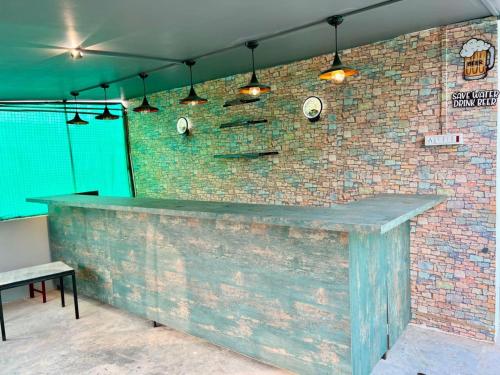 a brick wall with a bar with lights on it at Om Kashi Villa in Varanasi