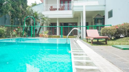 a swimming pool in front of a house at Villa Venetys Lembang by BWB in Cikidang 1