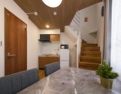 a kitchen and dining room with a table and a staircase at japan house Ikebukuro 2 in Tokyo