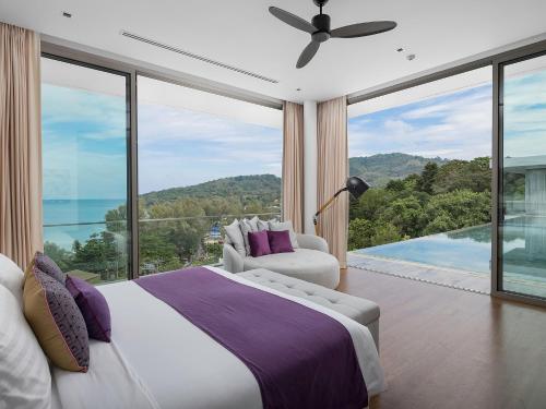 a bedroom with a bed and a large window at Malaiwana Residences in Nai Thon Beach