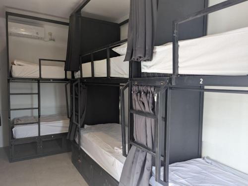 a group of bunk beds in a room at Mad Monkey Kuta Lombok in Kuta Lombok