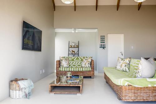 a living room with a couch and a table at Perlemoentjie in Britannia Bay