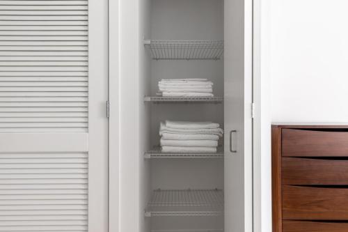 a closet with white towels on shelves at Loop Studio w Gym Pool nr Financial District CHI-239 in Chicago