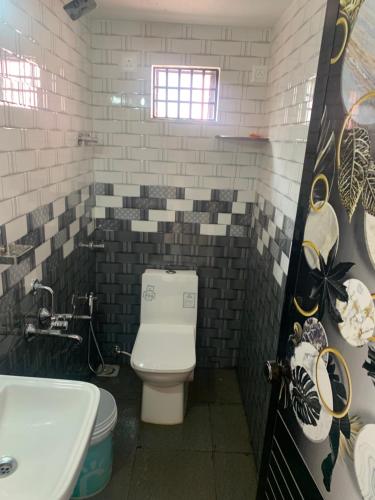 a bathroom with a toilet and a sink at Bethel Homestay Honnavar in Honāvar