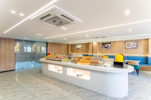 a bakery with a counter with food on it at Holiday Inn Express Suzhou City Center by IHG in Suzhou