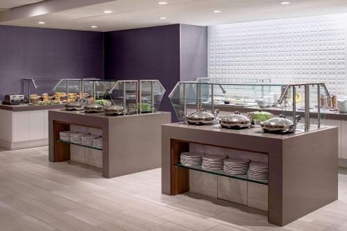 a buffet in a restaurant with plates and food at Grand Hyatt Washington in Washington