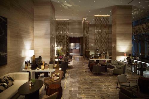 a lobby of a hotel with tables and chairs at Park Hyatt New York in New York