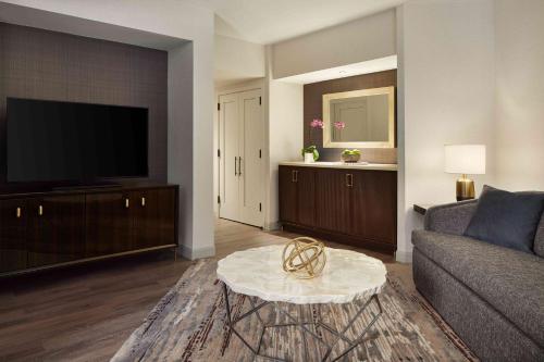 a living room with a couch and a tv at Grand Hyatt Washington in Washington