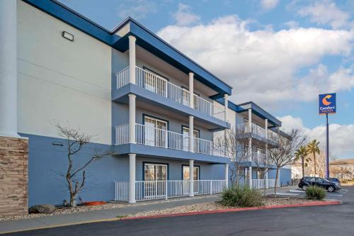 a blue apartment building with a parking lot at Comfort Suites Red Bluff near I-5 in Red Bluff