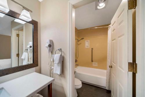 a bathroom with a sink and a toilet and a mirror at Comfort Suites Red Bluff near I-5 in Red Bluff