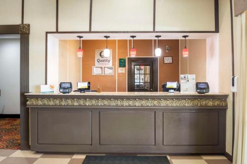 a lobby of a hotel with a reception counter at Quality Suites Hickory South in Hickory