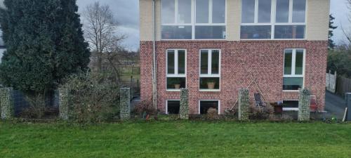 a large brick building with a large window at Rheinufer in Xanten