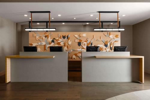 a lobby with two counters with birds on the wall at Spirit Ridge, in The Unbound Collection by Hyatt in Osoyoos