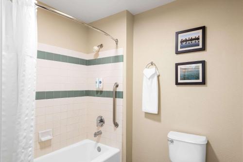 a bathroom with a tub and a toilet and a shower at MainStay Suites El Centro I-8 in El Centro